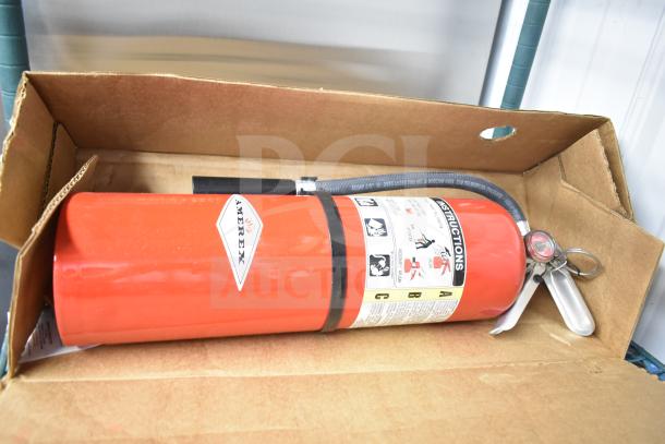 Brand new Amerex fire extinguisher in box, with label showing usage instructions.