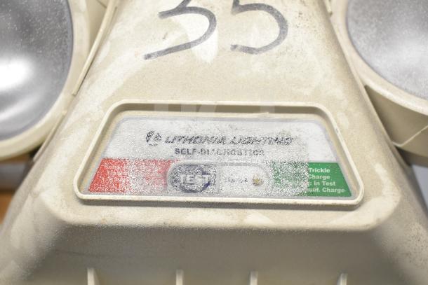 Emergency light by Lithonia Lighting, labeled "SELF 4 INTEGRATED N T 35," showing charge status, dusty condition.