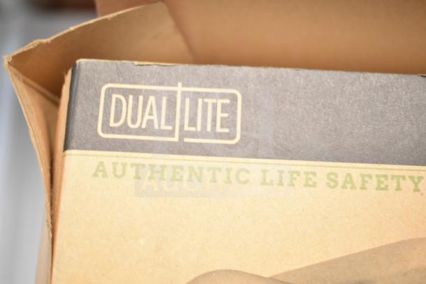 Box for Dual-Lite Emergency Light labeled "Authentic Life Safety," part of auction offering six various items.