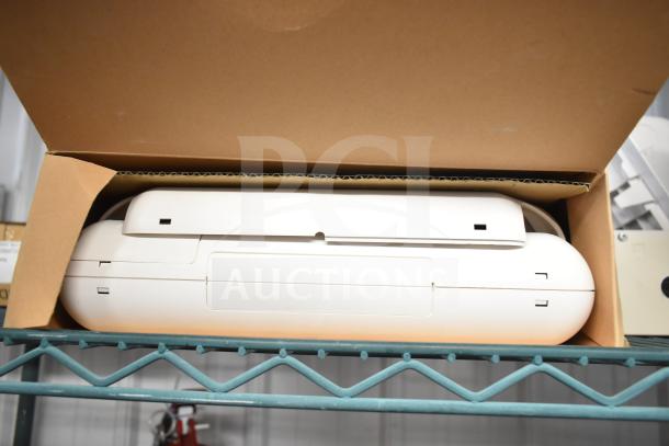 Cardboard box containing a white emergency light, partially visible, placed on a metal shelf.