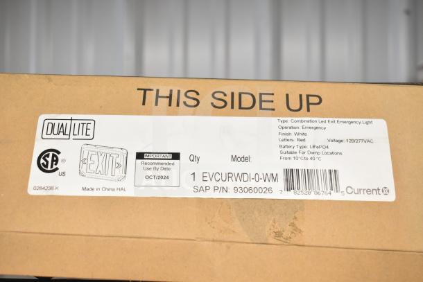 Cardboard box showing Dual Lite combination LED exit emergency light with model EVCURWDI-0-WM. Recommended use by October 2024. Made for damp locations, uses LiFePO4 battery.