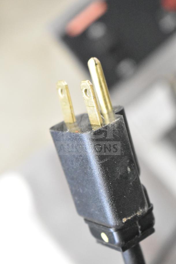 Close-up of a plug from a Nemco 7020A-S240 Belgian waffle maker. 240V, 1 Phase, new condition with minor scratches.