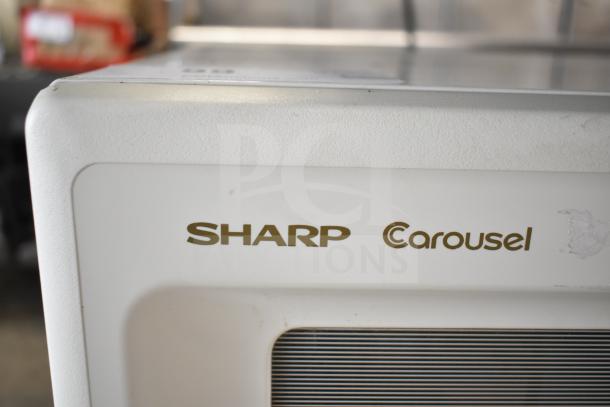Sharp Carousel R-3A47 countertop microwave oven with plate, 120V, 1 Phase, used condition, visible logo on the front.