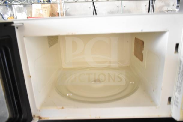 Sharp Carousel R-3A47 countertop microwave, white interior, includes glass plate, 120 volts, used condition.