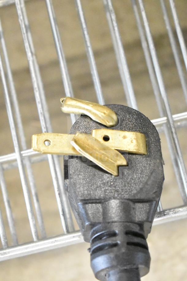 A damaged power plug on a QNC GFII commercial countertop fryer, brand new but with visible scratches.