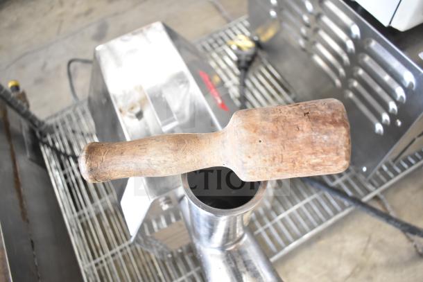 Avantco MG22 Commercial Meat Grinder, 110V, 1 Phase, shown with wooden tool, stainless steel finish, in used condition.