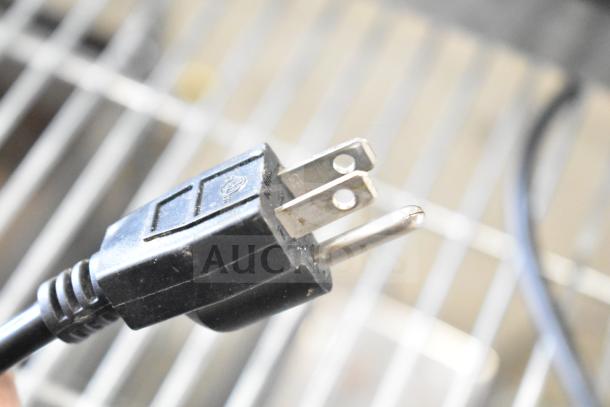 Close-up of a black power plug for the VacPak-It 186VME16SS vacuum packaging machine, 120 volts.