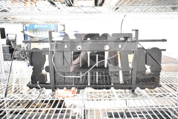 Tequila Cazadores metal sign with cut-out design, featuring silhouettes. Mounted on metal shelving. Wires visible, good condition.