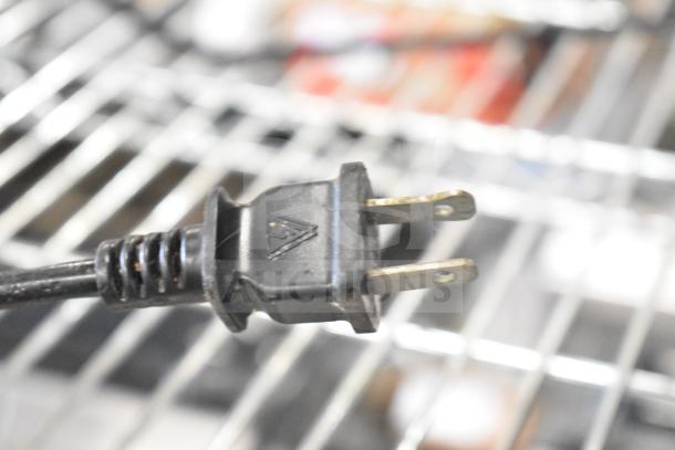 Cuisinart food processor 120V plug, close-up. Features durable connector for countertop model.