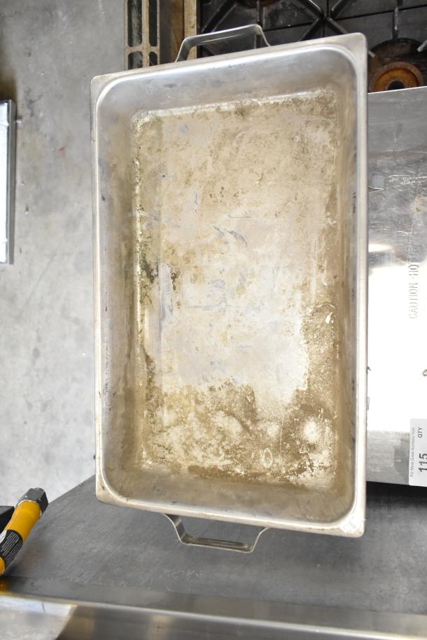 Used countertop chafer, rectangular shape, metal with handles, showing wear and discoloration, suitable for food service.