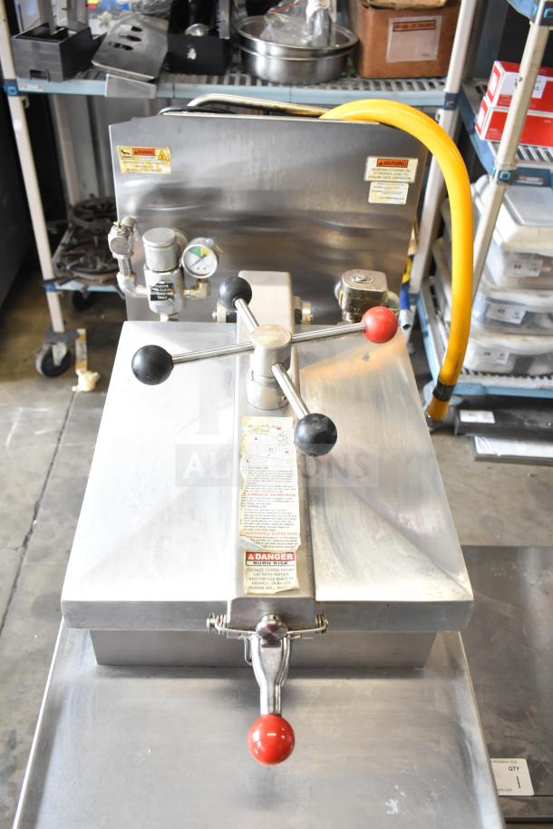 2022 Henny Penny 600 pressure fryer, natural gas, 80,000 BTU, on casters. Features control panel, gauge, warning labels.