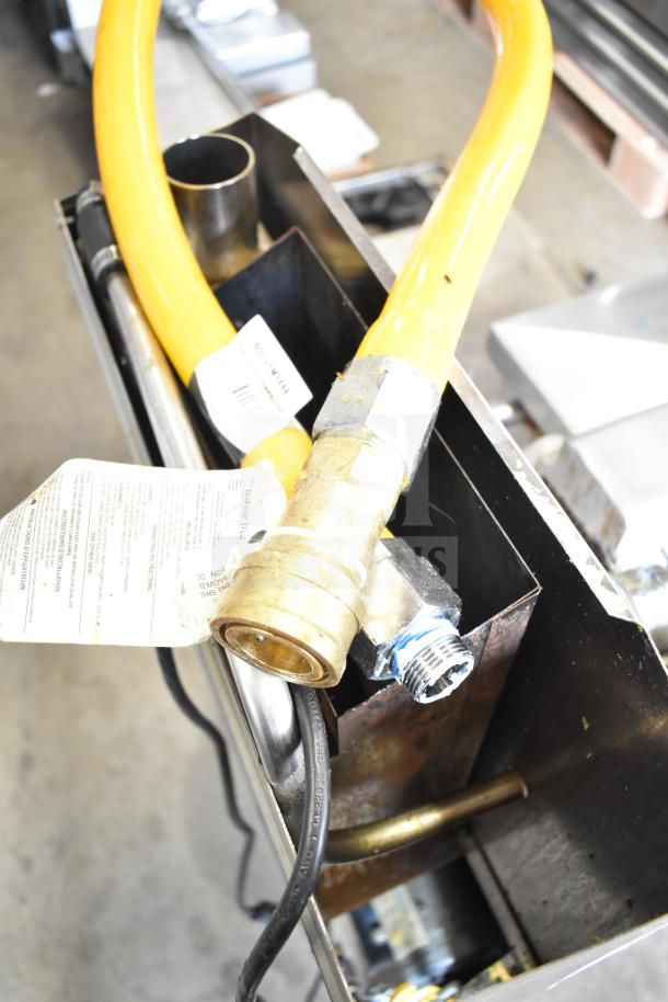 2022 Henny Penny 600 commercial pressure fryer with natural gas connection, showing setup components and condition.