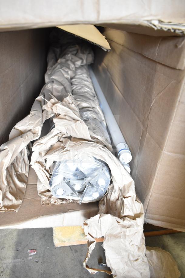 Box containing Philips tube lights, PT44070 2x4 LED light panel components, packaged in brown paper for auction.