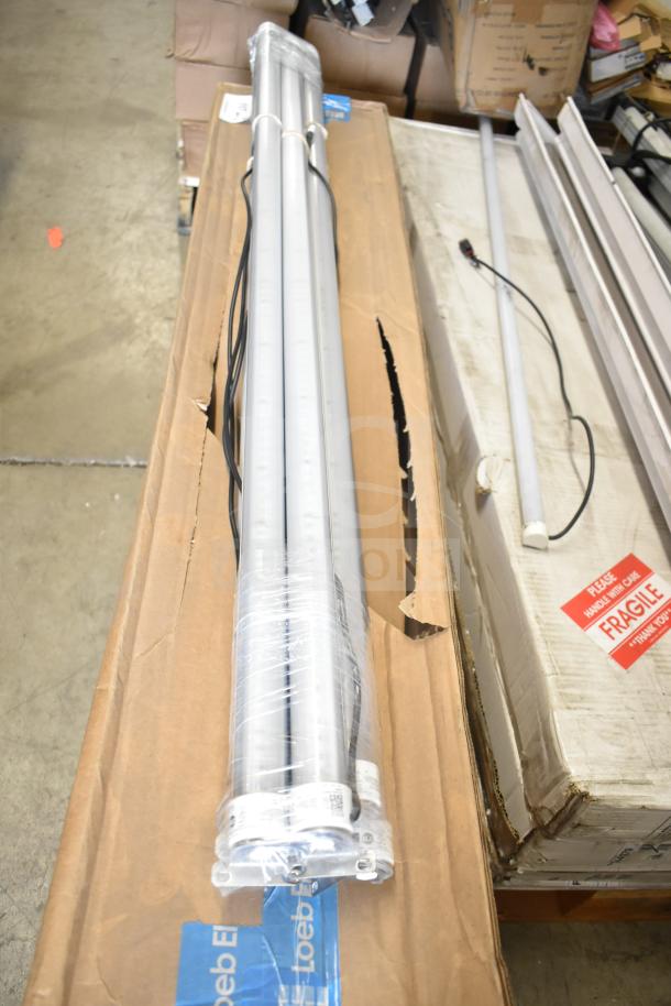 Set of Philips tube lights and PT44070 2x4 LED light panel, new condition, packaged in boxes with "Fragile" labels.