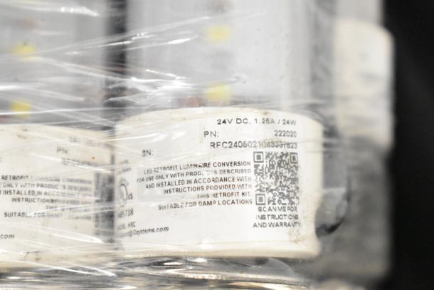 Philips tube lights wrapped in plastic with visible label showing 24V DC, 1.25A, model PT44070, QR code for instructions.