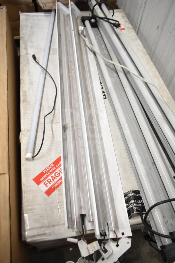 Various Philips tube lights and PT44070 2x4 LED light panel, assorted condition, labeled "Fragile."