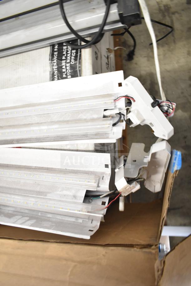 Six assorted lighting items, including Philips tube lights and PT44070 2x4 LED panels, in used condition, some wires exposed.