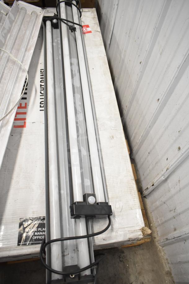 Six various items including Philips tube lights and PT44070 2x4 LED light panel, in packaging, appear unused.