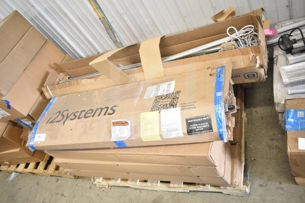 Cardboard boxes containing various i2Systems items and light strips, some packaging worn. Labels include installation instructions.