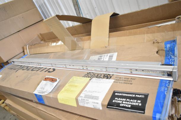 Cardboard box with i2Systems light strips, visible labels detailing installation instructions and usage. Box shows wear.