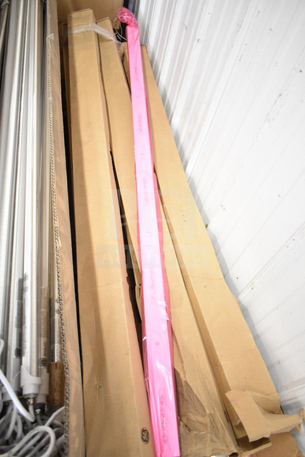 Various light strips and i2Systems items bundled in packaging. Includes pink-wrapped strip and power cords. Good condition.