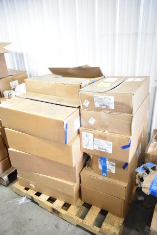 Boxes of 16 various items including GE K5SM flood light, stacked on a pallet. Some boxes show shipping labels.