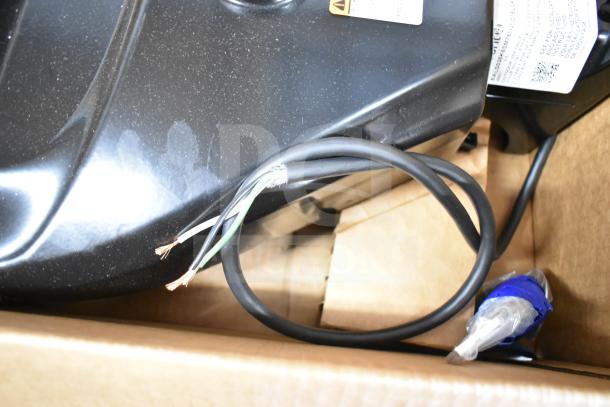 Box containing 16 assorted items, including a GE K5SM flood light. Items in varying condition with visible wiring and labels.
