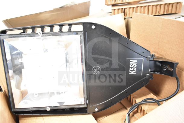GE K5SM flood light, black, in new condition. Includes 16 items per bid. Marked with GE logo and model label.