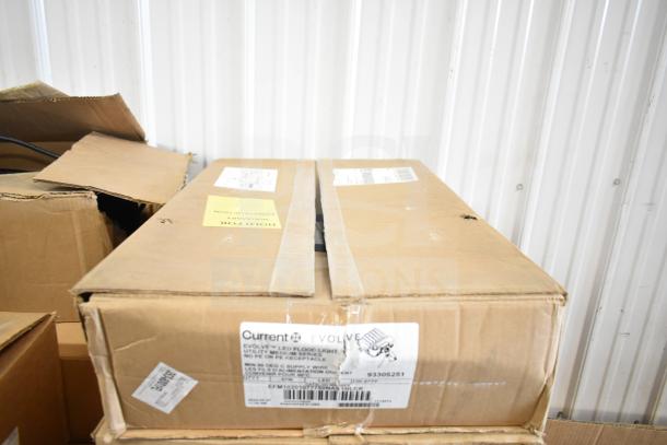 Cardboard box labeled "Current Evolve" with GE K5SM flood light inside, featuring item details and a shipping label.