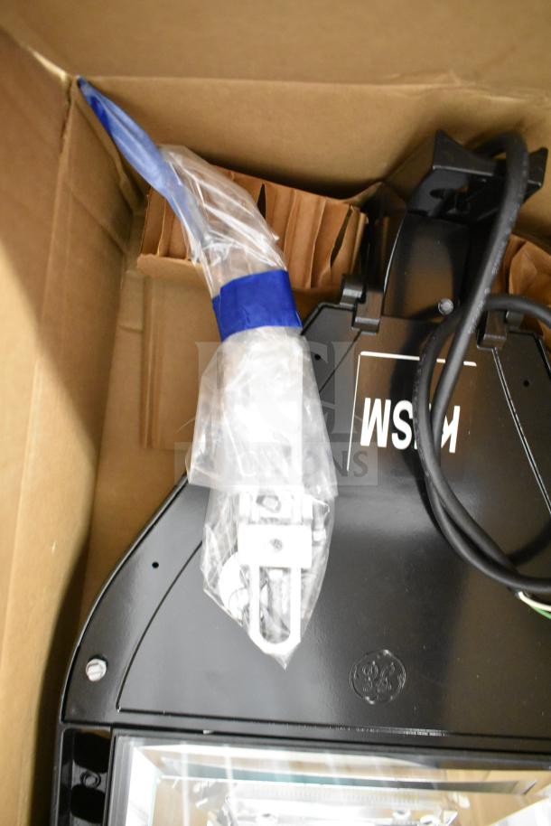 Boxed GE K5SM flood light, new condition, with mounting hardware. Part of a 16-item auction lot.