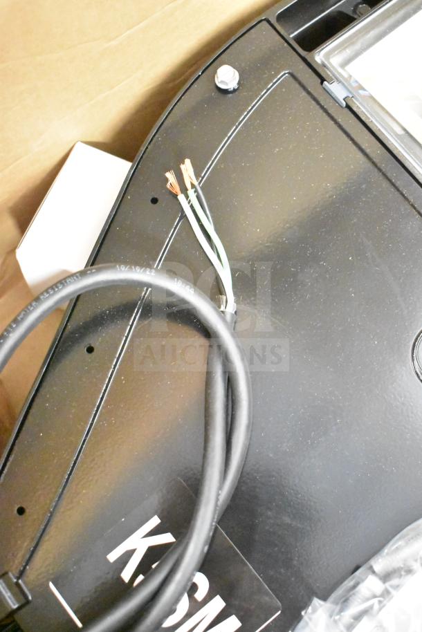 GE K5SM flood light, unused, black, visible wires, part of 16-item auction lot.