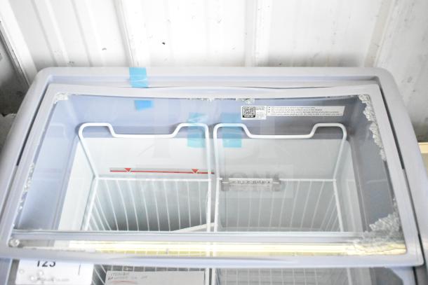 Avantco 360DFC6HCL ice cream freezer with curved top, 26 3/16", new scratch and dent, 115V, visible damage on top.