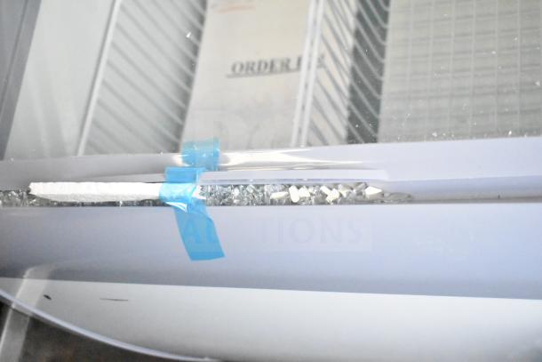 Brand new Avantco 360DFC6HCL ice cream freezer, 26 3/16", curved top, visible scratch and dent damage, 115 volts, 1 phase.