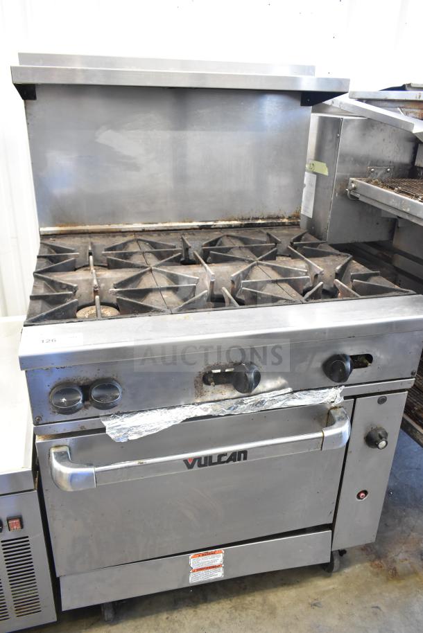 Vulcan 36S-Y1A commercial gas range with 6 burners, oven, overshelf, backsplash, on casters, 215,000 BTU, in used condition.