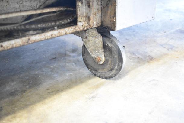 Close-up of worn caster on Vulcan 36S-Y1A commercial gas range. Visible rust and wear indicate used condition.