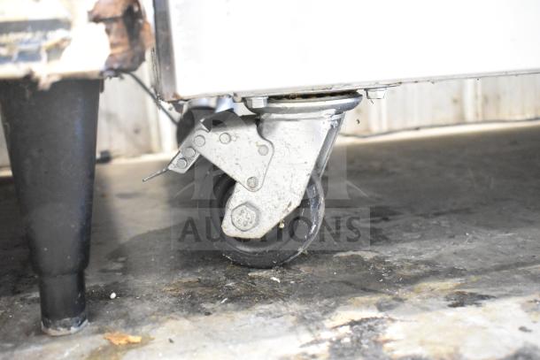 Avantco 178CBE60HC 2 Drawer Chef Base on commercial casters, 115V, visible moderate wear on casters.