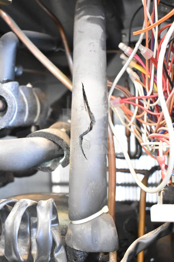 Hoshizaki KM-1301SWH ice head and bin, 208-230V, internal view showing wiring and damaged insulation.