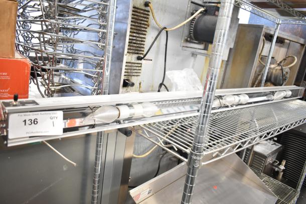 Vollrath Cayenne Light Strip in good condition, mounted on a metal shelf. Includes a tag with auction details and wiring visible.