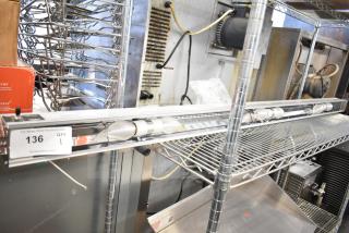 Vollrath Cayenne Light Strip in good condition, mounted on a metal shelf. Includes a tag with auction details and wiring visible.