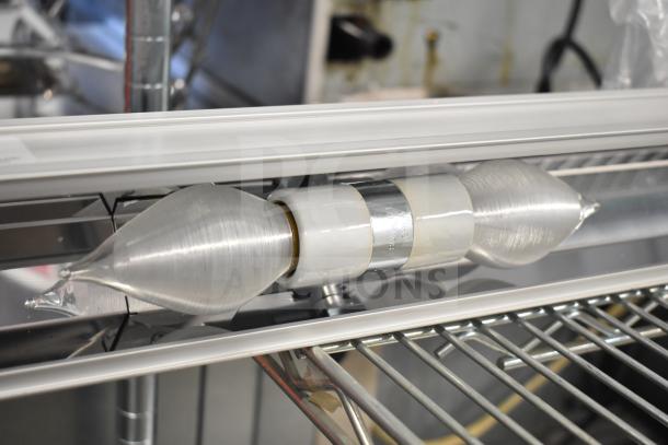Vollrath Cayenne light strip with metal casing, in good condition, mounted on a metal rack. Suitable for commercial kitchen use.