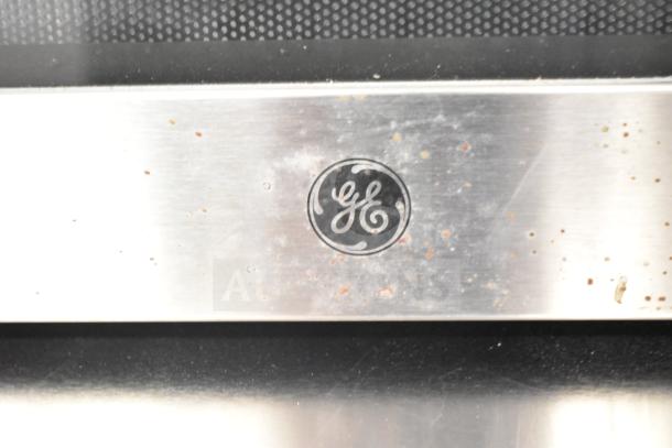 2019 GE JES1657SM1SS countertop microwave, stainless steel, visible GE logo, minor wear. Model JES1657SM1SS, 120V, 1 Phase.