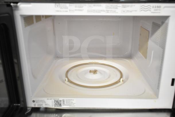 2019 GE JES1657SM1SS countertop microwave, 120 volts, open view. Interior shows signs of use, 1 phase power.
