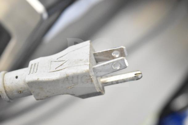 Close-up view of the plug of a General Electric GE JES1657SM1SS countertop microwave oven.