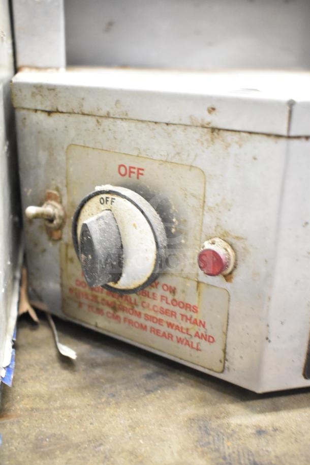 Autodoner 3PG countertop natural gas vertical broiler, 30,000 BTU, showing control knob and switch, moderate wear.