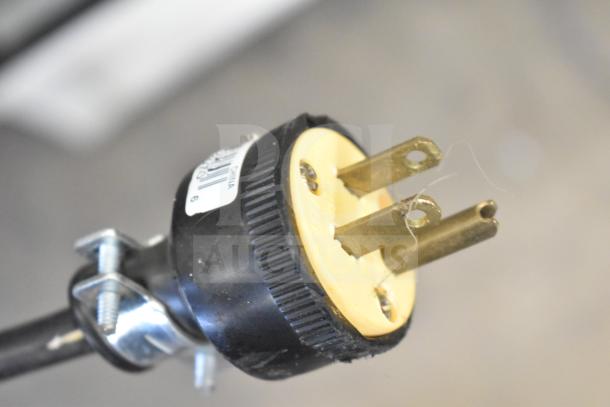 Close-up of a power plug for the Beverage Air MT27 cooler, showing prongs and label indicating 115 volts.