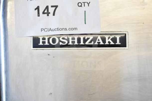 Hoshizaki KM-515MWH commercial ice head on ice bin, 115-120V, 1 phase, metal body, Hoshizaki logo plate visible.