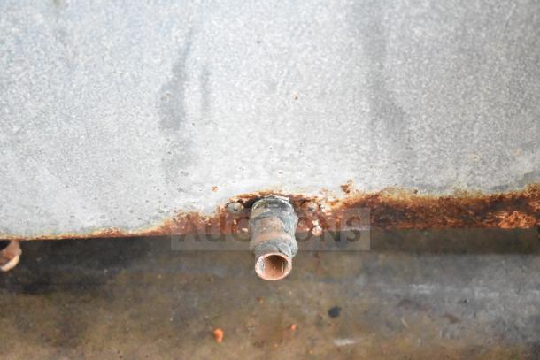 Alt text: Hoshizaki KM-515MWH commercial ice head attached to commercial ice bin. Features visible rust and corrosion.
