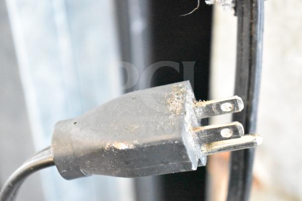 Power plug of Hoshizaki KM-515MWH Commercial Ice Head, 115-120 Volts, 1 Phase, slightly dusty, showing prongs.