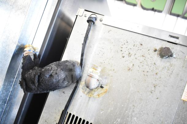 Hoshizaki KM-515MWH ice head on commercial bin, 115-120V, 1 phase, shown with worn insulation and metal connectors.