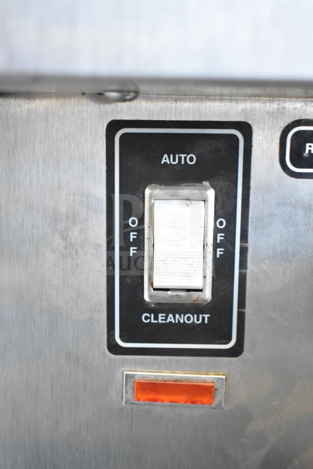 SaniServ W5273P soft serve machine switch panel, showing auto and cleanout settings. Stainless steel finish.